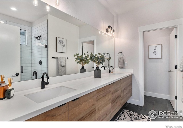 3580 W 62nd Pl, Denver, CO 80221 - bathroom with tile patterned flooring, double vanity, tiled shower, baseboards, and recessed lighting