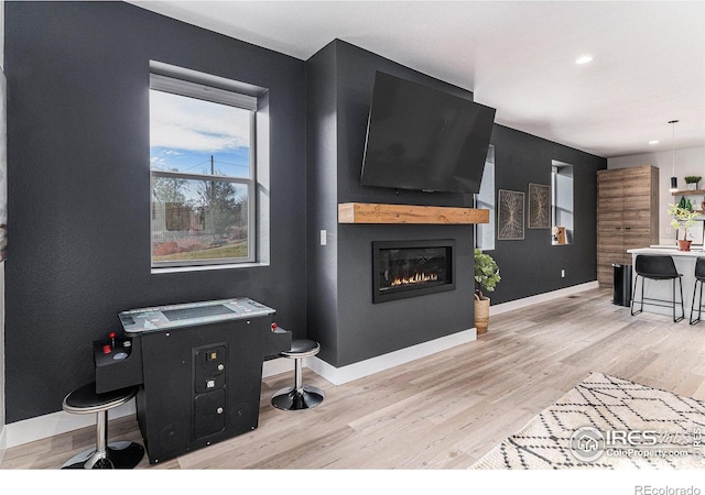 3580 W 62nd Pl, Denver, CO 80221 - living room with light wood-style flooring, a glass covered fireplace, baseboards, and recessed lighting
