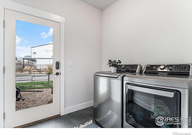 3580 W 62nd Pl, Denver, CO 80221 - washroom featuring washer and clothes dryer, baseboards, and tile patterned floors