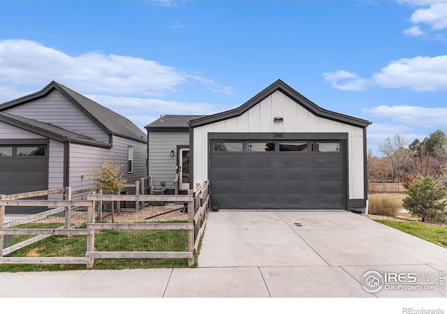 3580 W 62nd Pl, Denver, CO 80221 - view of front of home featuring driveway, board and batten siding, and a garage