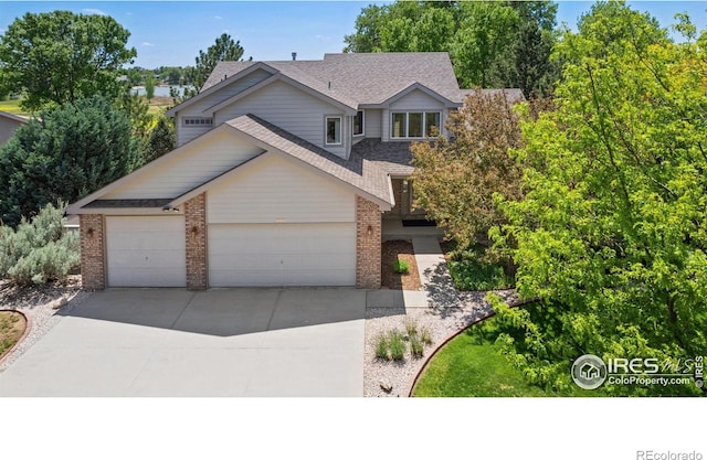 140 Camino Real Ft, Collins, CO 80524 - traditional home featuring brick siding, a shingled roof, concrete driveway, and a garage