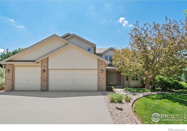 140 Camino Real Ft, Collins, CO 80524 - view of front of house with brick siding, a garage, and concrete driveway
