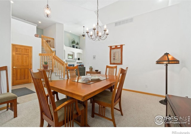 140 Camino Real Ft, Collins, CO 80524 - dining area featuring a high ceiling, stairs, a chandelier, recessed lighting, and light colored carpet