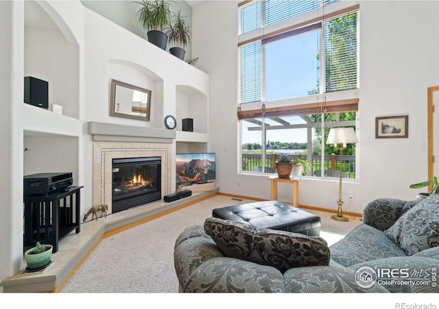 140 Camino Real Ft, Collins, CO 80524 - carpeted living room featuring a high ceiling, a premium fireplace, and baseboards