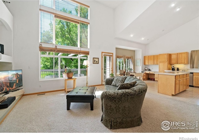 140 Camino Real Ft, Collins, CO 80524 - living area featuring a high ceiling, light carpet, recessed lighting, baseboards, and arched walkways