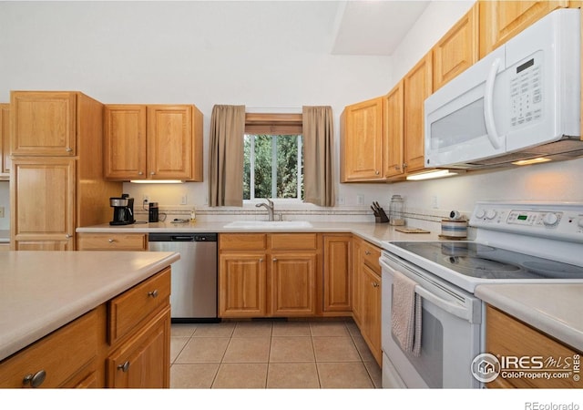 140 Camino Real Ft, Collins, CO 80524 - kitchen featuring white appliances, a sink, light countertops, light tile patterned flooring, and a high ceiling