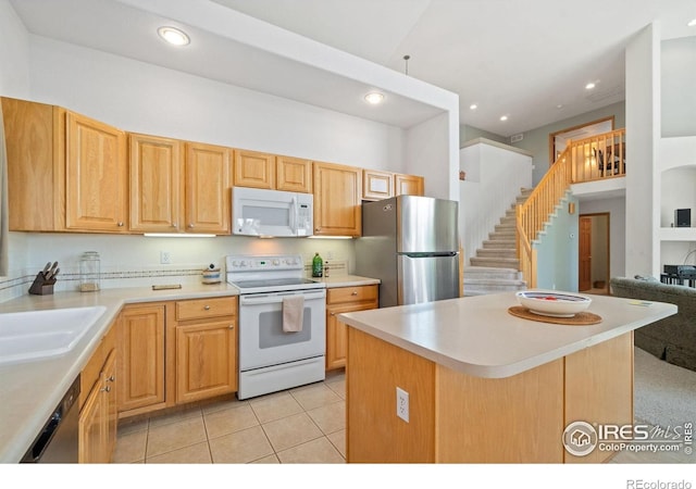140 Camino Real Ft, Collins, CO 80524 - kitchen with appliances with stainless steel finishes, light countertops, a sink, recessed lighting, and a kitchen island