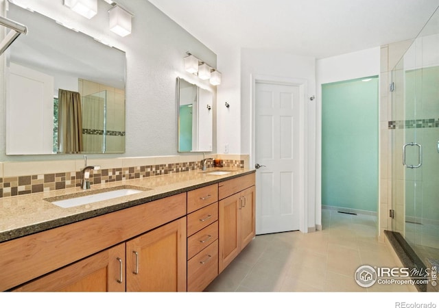 140 Camino Real Ft, Collins, CO 80524 - full bathroom with a stall shower, double vanity, tile patterned floors, and tasteful backsplash