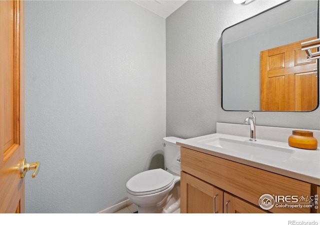 140 Camino Real Ft, Collins, CO 80524 - bathroom with vanity, toilet, and a textured wall