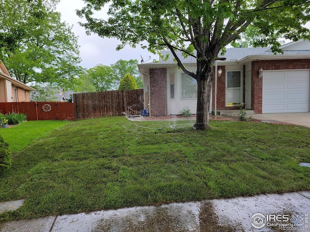 1126 Patricia Dr, Loveland, CO 80537 - view of yard featuring a garage and concrete driveway