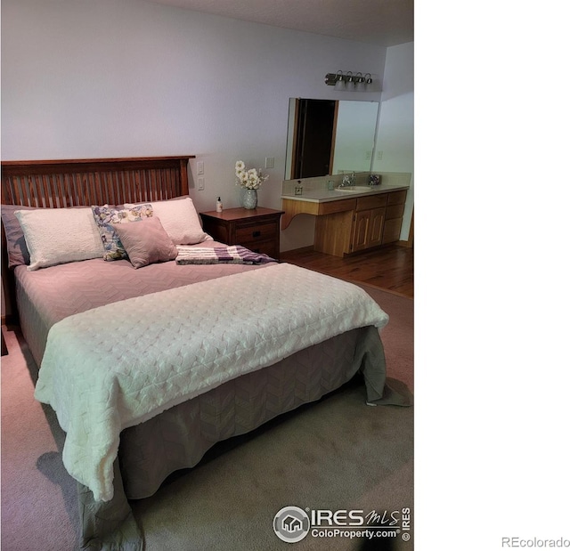 1126 Patricia Dr, Loveland, CO 80537 - carpeted bedroom with a sink