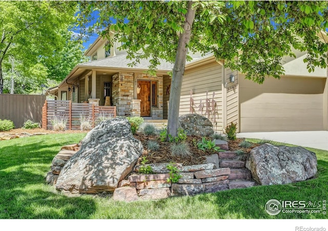 3345 15th St, Boulder, CO 80304 - view of front of house featuring covered porch, driveway, an attached garage, and stone siding