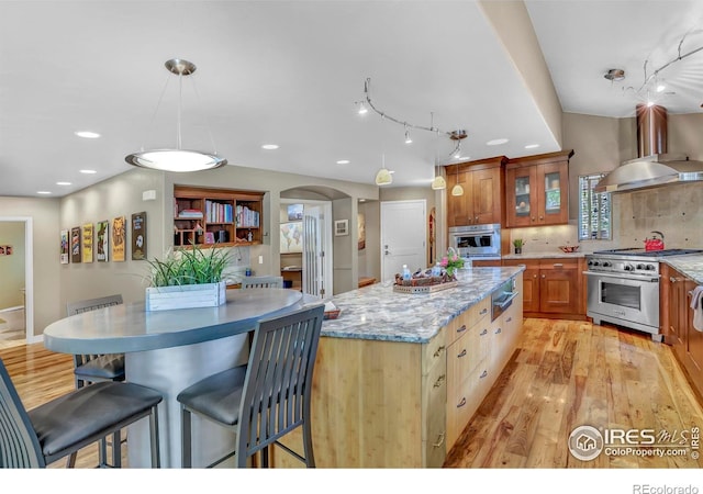 3345 15th St, Boulder, CO 80304 - kitchen with appliances with stainless steel finishes, island exhaust hood, a center island, track lighting, and light wood-style floors
