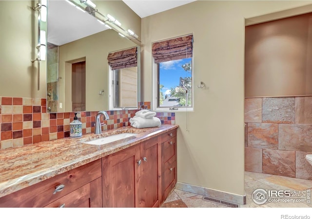 3345 15th St, Boulder, CO 80304 - bathroom featuring vanity, backsplash, and baseboards
