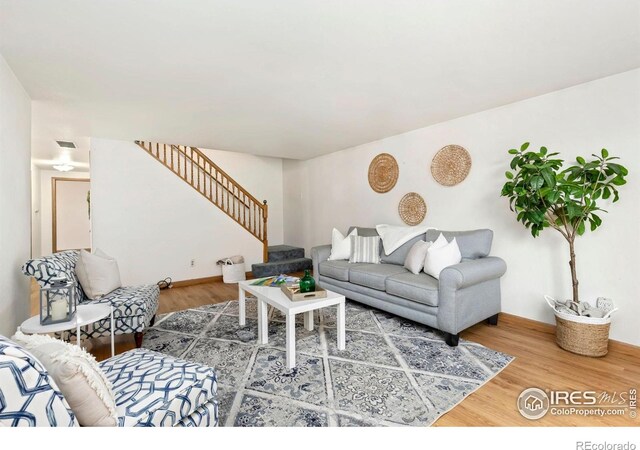 911 Timber Ct, Longmont, CO 80504 - living room with stairs, wood finished floors, and baseboards
