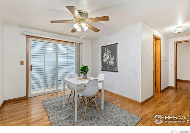 911 Timber Ct, Longmont, CO 80504 - dining room featuring baseboards, light wood-type flooring, and a ceiling fan
