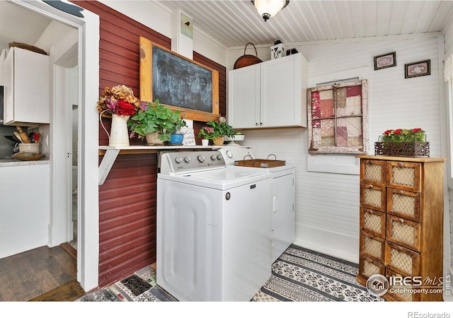 3730 Garfield Ave, Wellington, CO 80549 - laundry area with washer and clothes dryer, cabinet space, dark wood-style floors, and wooden walls