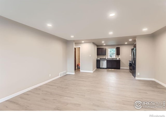 3014 High Dr, Evans, CO 80620 - unfurnished living room with light wood finished floors, baseboards, a sink, and recessed lighting