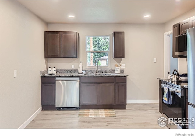 3014 High Dr, Evans, CO 80620 - kitchen with stainless steel appliances, a sink, light wood-style floors, light stone counters, and recessed lighting