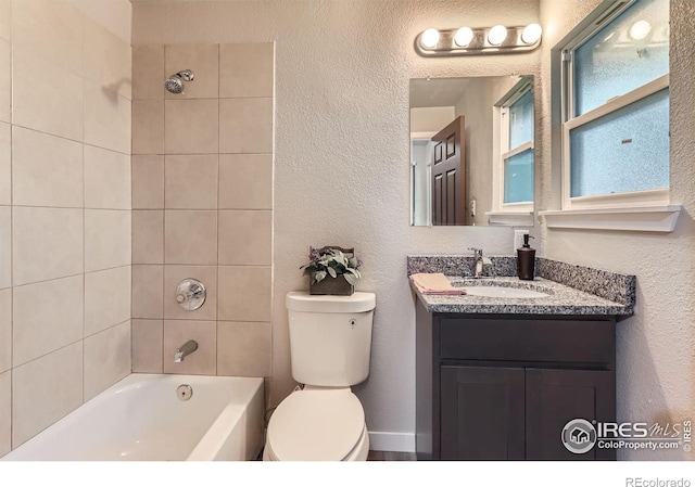 3014 High Dr, Evans, CO 80620 - bathroom with toilet, vanity, shower / bathtub combination, and a textured wall