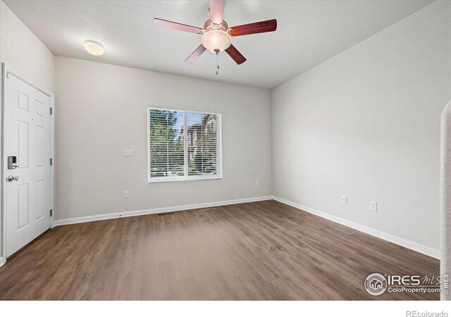 1426 Sepia Ave, Longmont, CO 80501 - spare room featuring wood finished floors, a ceiling fan, and baseboards