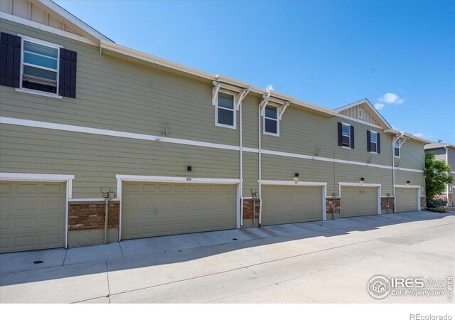 1426 Sepia Ave, Longmont, CO 80501 - back of house with board and batten siding and a garage