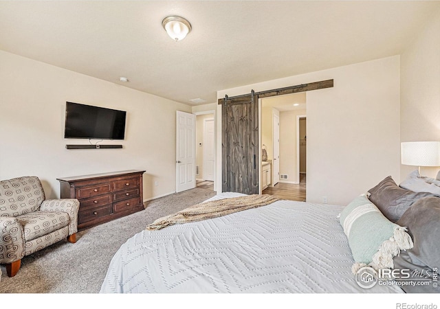 6253 Black Mesa Rd, Frederick, CO 80516 - bedroom featuring a barn door, carpet, and baseboards