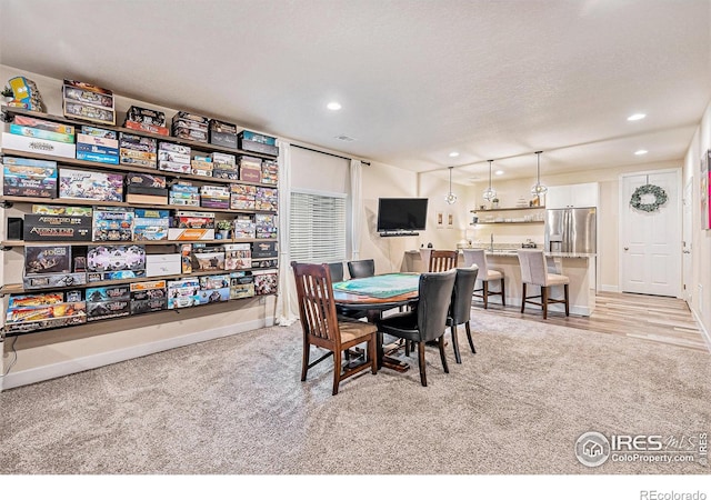 6253 Black Mesa Rd, Frederick, CO 80516 - dining space with light colored carpet, recessed lighting, baseboards, and a textured ceiling