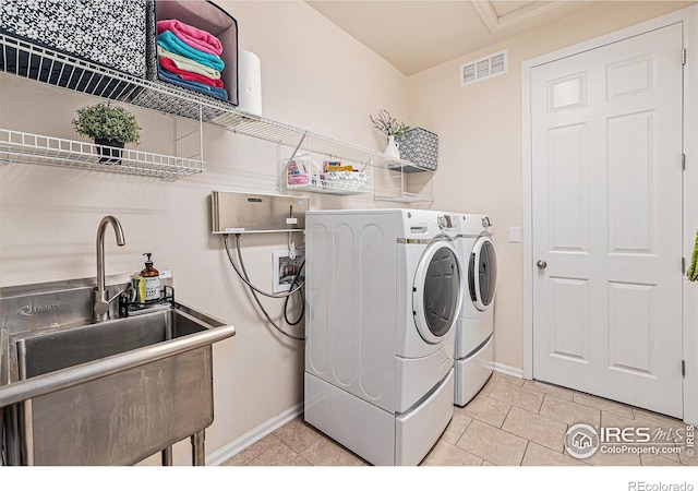 6253 Black Mesa Rd, Frederick, CO 80516 - laundry room featuring washer and dryer, baseboards, and light tile patterned flooring