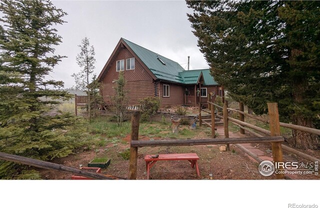 311 Chiricahua Cir, Red Feather Lakes, CO 80545 - view of side of property featuring metal roof and log exterior