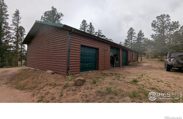 311 Chiricahua Cir, Red Feather Lakes, CO 80545 - view of side of property featuring log veneer siding and an outdoor structure