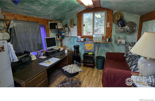 311 Chiricahua Cir, Red Feather Lakes, CO 80545 - office with wood finished floors, a wood stove, and vaulted ceiling