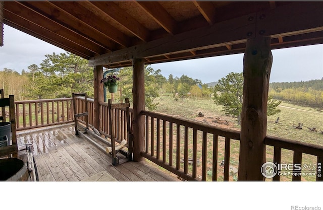 311 Chiricahua Cir, Red Feather Lakes, CO 80545 - wooden terrace with a forest view