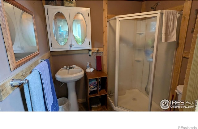 311 Chiricahua Cir, Red Feather Lakes, CO 80545 - bathroom with a stall shower, toilet, and a sink