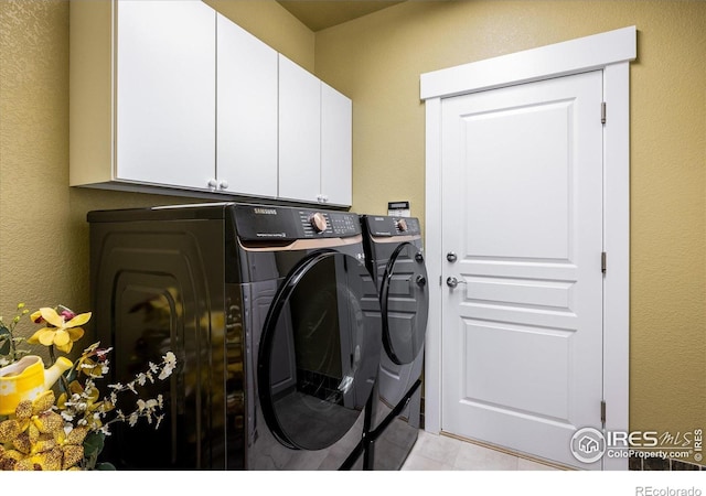 2758 Meadow Mountain Trl, Lafayette, CO 80026 - laundry area with separate washer and dryer, cabinet space, light tile patterned floors, and a textured wall