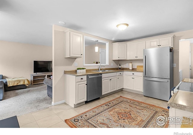 437 Fox St, Longmont, CO 80504 - kitchen featuring stainless steel appliances, light tile patterned flooring, open floor plan, and a sink