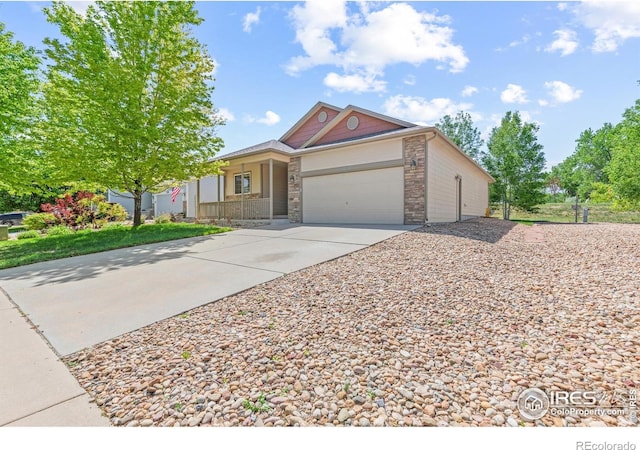 8734 19th Street Rd, Greeley, CO 80634 - view of front of house featuring covered porch, driveway, and an attached garage