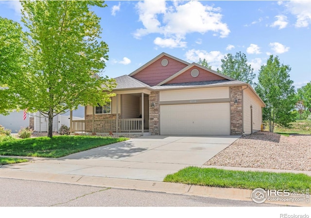 8734 19th Street Rd, Greeley, CO 80634 - view of front of property featuring a porch, an attached garage, driveway, and a shingled roof