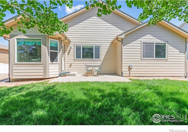 8734 19th Street Rd, Greeley, CO 80634 - rear view of house with a patio and a lawn