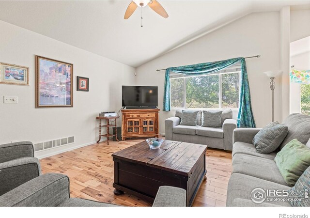 8734 19th Street Rd, Greeley, CO 80634 - living area with vaulted ceiling, plenty of natural light, ceiling fan, light wood-style flooring, and baseboards
