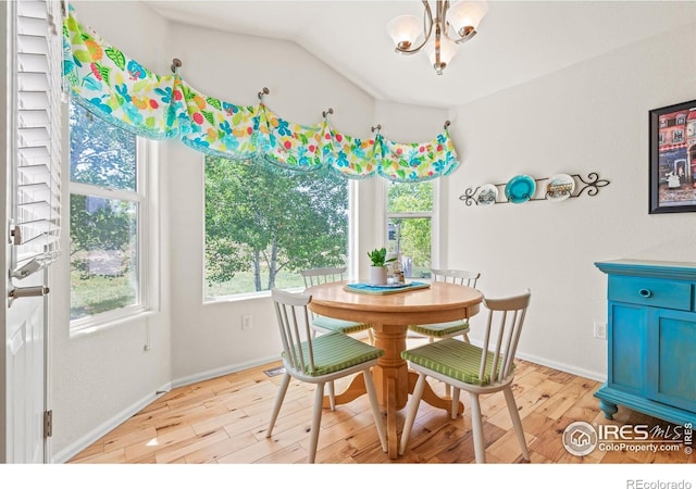 8734 19th Street Rd, Greeley, CO 80634 - dining area featuring a chandelier, light wood-style flooring, baseboards, and vaulted ceiling