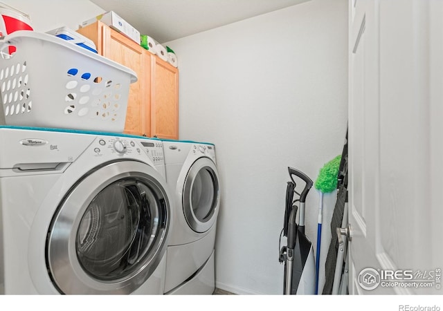 8734 19th Street Rd, Greeley, CO 80634 - laundry area featuring washer and dryer, cabinet space, and baseboards