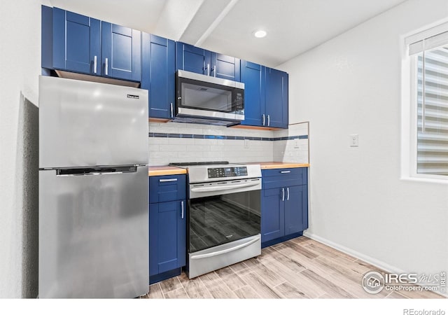 8734 19th Street Rd, Greeley, CO 80634 - kitchen featuring stainless steel appliances, blue cabinetry, butcher block countertops, and recessed lighting