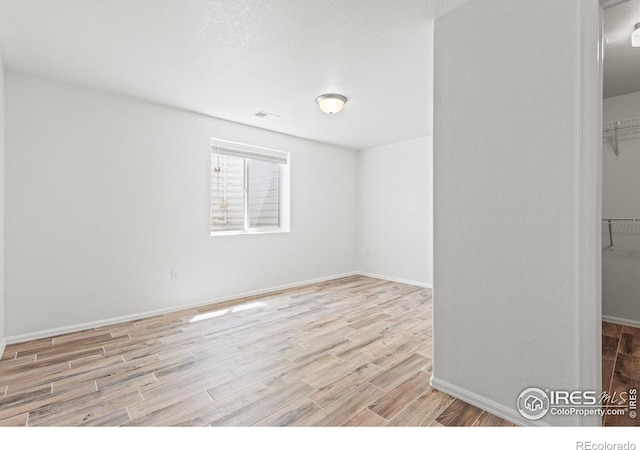 8734 19th Street Rd, Greeley, CO 80634 - unfurnished room featuring wood finished floors and baseboards