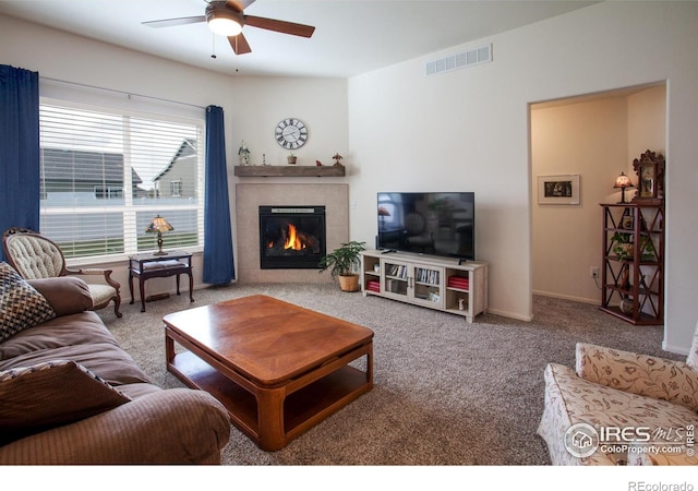 944 Maplebrook Dr, Windsor, CO 80550 - living area featuring ceiling fan, a tiled fireplace, carpet flooring, and baseboards