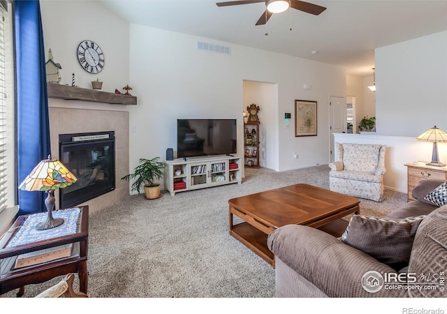 944 Maplebrook Dr, Windsor, CO 80550 - carpeted living area with ceiling fan and a tile fireplace