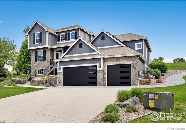 7427 Couples Ct, Fort Collins, CO 80528 - view of front of property featuring stone siding, concrete driveway, an attached garage, and board and batten siding