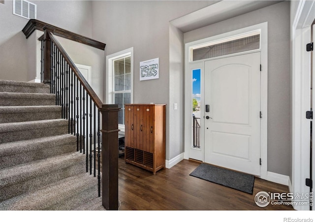 7427 Couples Ct, Fort Collins, CO 80528 - foyer entrance featuring dark wood-style flooring, baseboards, and stairs