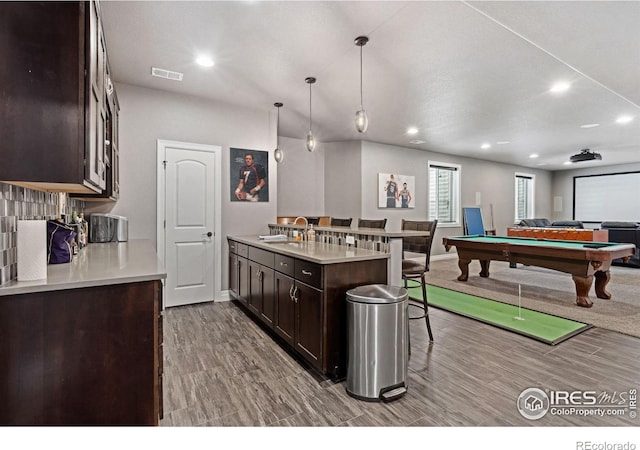 7427 Couples Ct, Fort Collins, CO 80528 - kitchen with dark brown cabinetry, baseboards, recessed lighting, light countertops, and open floor plan