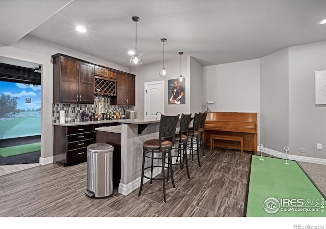 7427 Couples Ct, Fort Collins, CO 80528 - indoor wet bar with wood tiled floors, tasteful backsplash, baseboards, decorative light fixtures, and recessed lighting